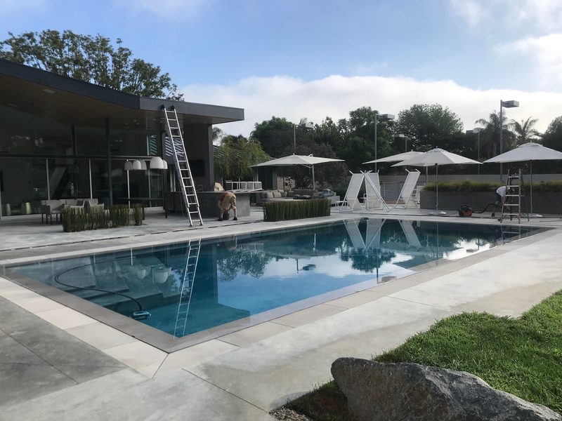 Modern home pool area during exterior cleaning